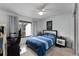 Bright bedroom featuring a double bed, desk, and wooded backyard view at 5316 Pebble Beach Dr # E, Orlando, FL 32811