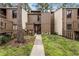 Charming condo with a landscaped front yard, walkway and brown wooden door, creating a warm welcome at 5316 Pebble Beach Dr # E, Orlando, FL 32811