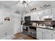 Bright eat-in kitchen with white cabinets, stainless steel appliances, and wood-look flooring at 5316 Pebble Beach Dr # E, Orlando, FL 32811