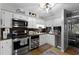 Well-equipped kitchen featuring white cabinets, stainless steel appliances, and wood flooring at 5316 Pebble Beach Dr # E, Orlando, FL 32811
