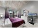 Main bedroom featuring a king bed, private balcony, and large TV at 5316 Pebble Beach Dr # E, Orlando, FL 32811