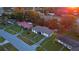 An aerial view shows the house with surrounding homes, landscaping, and street access at 1048 Wakefield Cir, Deltona, FL 32725