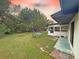 This backyard has a grassy yard, table with chairs and screened-in back porch at 1048 Wakefield Cir, Deltona, FL 32725