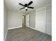 Bedroom with wood floors, ceiling fan, closet, and bathroom access at 1048 Wakefield Cir, Deltona, FL 32725