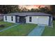 Charming single-story home featuring stucco siding, stone accents, and a well-maintained front yard at 1048 Wakefield Cir, Deltona, FL 32725