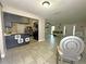 Open kitchen and living room with tiled floor, modern light fixtures, and stainless steel appliances at 1048 Wakefield Cir, Deltona, FL 32725