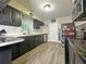 Modern kitchen with black cabinets, stainless steel appliances, and a window over the sink at 1048 Wakefield Cir, Deltona, FL 32725