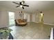 Bright living area boasts tile floors, modern ceiling fan and comfortable seating arrangement at 1048 Wakefield Cir, Deltona, FL 32725