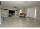 Open-concept living room features tile flooring, a ceiling fan, and lots of natural light at 1048 Wakefield Cir, Deltona, FL 32725