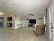 Spacious living room with tile flooring, comfortable seating, and a view of the kitchen area at 1048 Wakefield Cir, Deltona, FL 32725