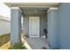 Covered front porch with light blue door and potted plants at 4815 Rigging St, Haines City, FL 33844
