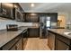 Dark wood cabinets, stainless steel appliances, and granite countertops at 4815 Rigging St, Haines City, FL 33844
