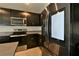 Stainless steel refrigerator and dark wood cabinetry in the kitchen at 4815 Rigging St, Haines City, FL 33844