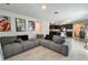 Open concept living room with gray sectional sofa and kitchen views at 4815 Rigging St, Haines City, FL 33844