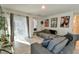 Sunlit living room featuring a gray sectional sofa and sliding glass doors at 4815 Rigging St, Haines City, FL 33844