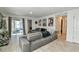 Bright living room with gray sectional sofa and access to a patio at 4815 Rigging St, Haines City, FL 33844