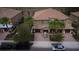 A beautiful home boasts a paver driveway, three-car garage, and mature landscaping at 8979 Azalea Sands Ln, Davenport, FL 33896