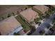 An aerial view shows mature landscaping, a paver driveway, and a three-car garage at 8979 Azalea Sands Ln, Davenport, FL 33896