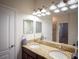 Bathroom features a double vanity with granite countertop and decorative lighting at 8979 Azalea Sands Ln, Davenport, FL 33896