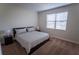 This bedroom features a neutral color scheme and a large window at 8979 Azalea Sands Ln, Davenport, FL 33896