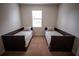 Bright bedroom with matching twin beds, tan carpeting, and a well lit window at 8979 Azalea Sands Ln, Davenport, FL 33896