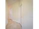 Bright hallway with neutral paint, white doors, and tiled flooring at 8979 Azalea Sands Ln, Davenport, FL 33896