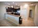 Well-equipped kitchen with dark cabinets, stainless steel appliances, and a breakfast bar at 8979 Azalea Sands Ln, Davenport, FL 33896