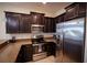 This kitchen is equipped with stainless steel appliances and granite countertops at 8979 Azalea Sands Ln, Davenport, FL 33896