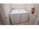 Clean laundry area with modern washer and dryer appliances, and a fire extinguisher at 8979 Azalea Sands Ln, Davenport, FL 33896