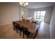 Spacious living room with a dining table, large sectional sofa, and sliding glass doors at 8979 Azalea Sands Ln, Davenport, FL 33896