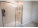 Clean shower with tile surround, glass door, and updated fixtures at 8979 Azalea Sands Ln, Davenport, FL 33896
