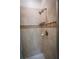 Updated shower with tan tiling, built in soap rack, and modern shower head at 8979 Azalea Sands Ln, Davenport, FL 33896