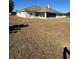View of the home's backyard with a screened patio at 9875 Sw 55Th Ct, Ocala, FL 34476
