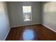 Spacious bedroom with hardwood floors and large window at 9875 Sw 55Th Ct, Ocala, FL 34476