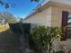 Side view showcasing the home's exterior and neatly trimmed hedges at 9875 Sw 55Th Ct, Ocala, FL 34476