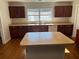 Kitchen with island, stainless steel appliances, and wood cabinets at 9875 Sw 55Th Ct, Ocala, FL 34476