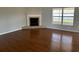 Living room with corner fireplace and wood-look flooring at 9875 Sw 55Th Ct, Ocala, FL 34476
