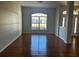 Spacious living room with wood-look floors and large window at 9875 Sw 55Th Ct, Ocala, FL 34476