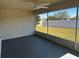 Spacious screened porch with ceiling fan and view of backyard at 9875 Sw 55Th Ct, Ocala, FL 34476