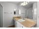 Bright bathroom features a vanity with ample counter space and a shower with glass door at 3623 Worth Cir, The Villages, FL 32162