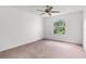 Bright bedroom with plush carpet, neutral walls, and sunny window view at 3623 Worth Cir, The Villages, FL 32162