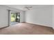 Spacious bedroom with carpet, ceiling fan, and sliding glass doors leading to the backyard at 3623 Worth Cir, The Villages, FL 32162