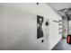 Garage wall with electrical panel, outlet and shelving at 3623 Worth Cir, The Villages, FL 32162