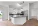 Modern kitchen with white cabinetry, stainless steel appliances, a breakfast bar, and views to the outside at 3623 Worth Cir, The Villages, FL 32162