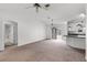 Expansive living room featuring neutral carpet and a door to the outdoor living space at 3623 Worth Cir, The Villages, FL 32162