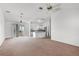 Bright living room open to the kitchen, featuring stainless steel appliances and lots of carpet space at 3623 Worth Cir, The Villages, FL 32162