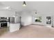 Bright living room open to the kitchen, featuring a breakfast bar, stainless steel appliances, and plenty of natural light at 3623 Worth Cir, The Villages, FL 32162