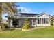 Back of house featuring an enclosed lanai and landscaped backyard at 3623 Worth Cir, The Villages, FL 32162