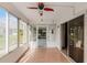 Bright sunroom with tile floors, multiple windows, and a ceiling fan at 3623 Worth Cir, The Villages, FL 32162
