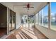 Bright sunroom with tile floors, multiple windows, and a ceiling fan at 3623 Worth Cir, The Villages, FL 32162